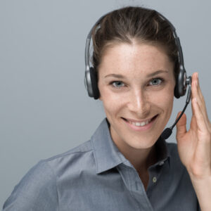 Smiling beautiful woman with headset: call center and customer support operator